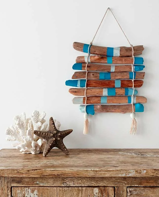 Composición decorativa de madera varada pintada en azul y blanco.